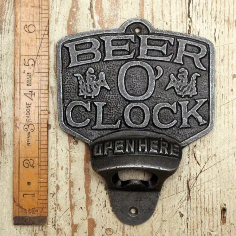 Beer O'Clock written on a wall mounted cast iron bottle opener