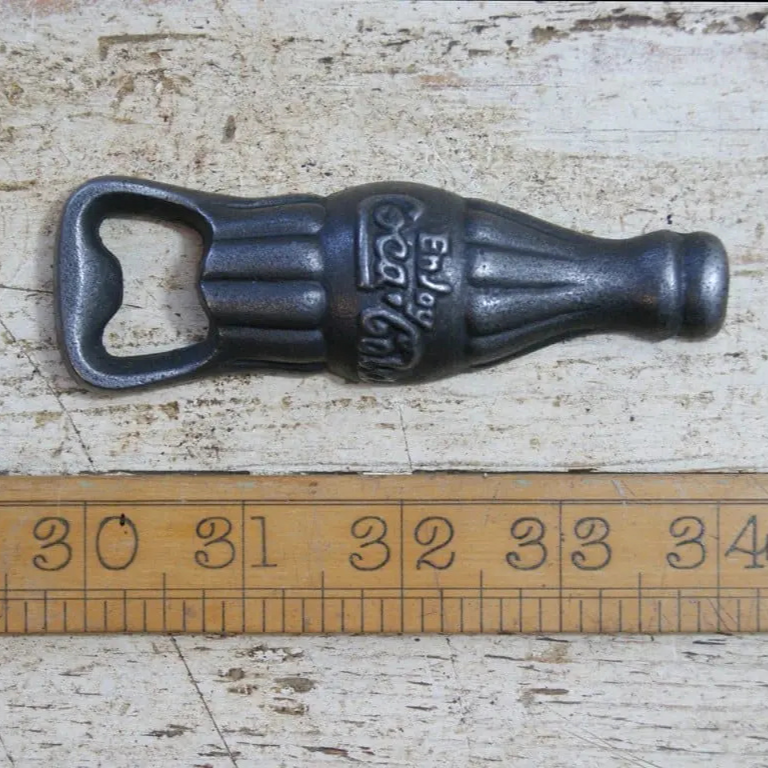 Coca-Cola bottle shaped cast iron hand held bottle opener