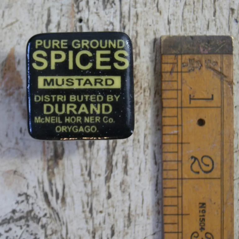 Square Ceramic knob with a traditional Spices logo/advert